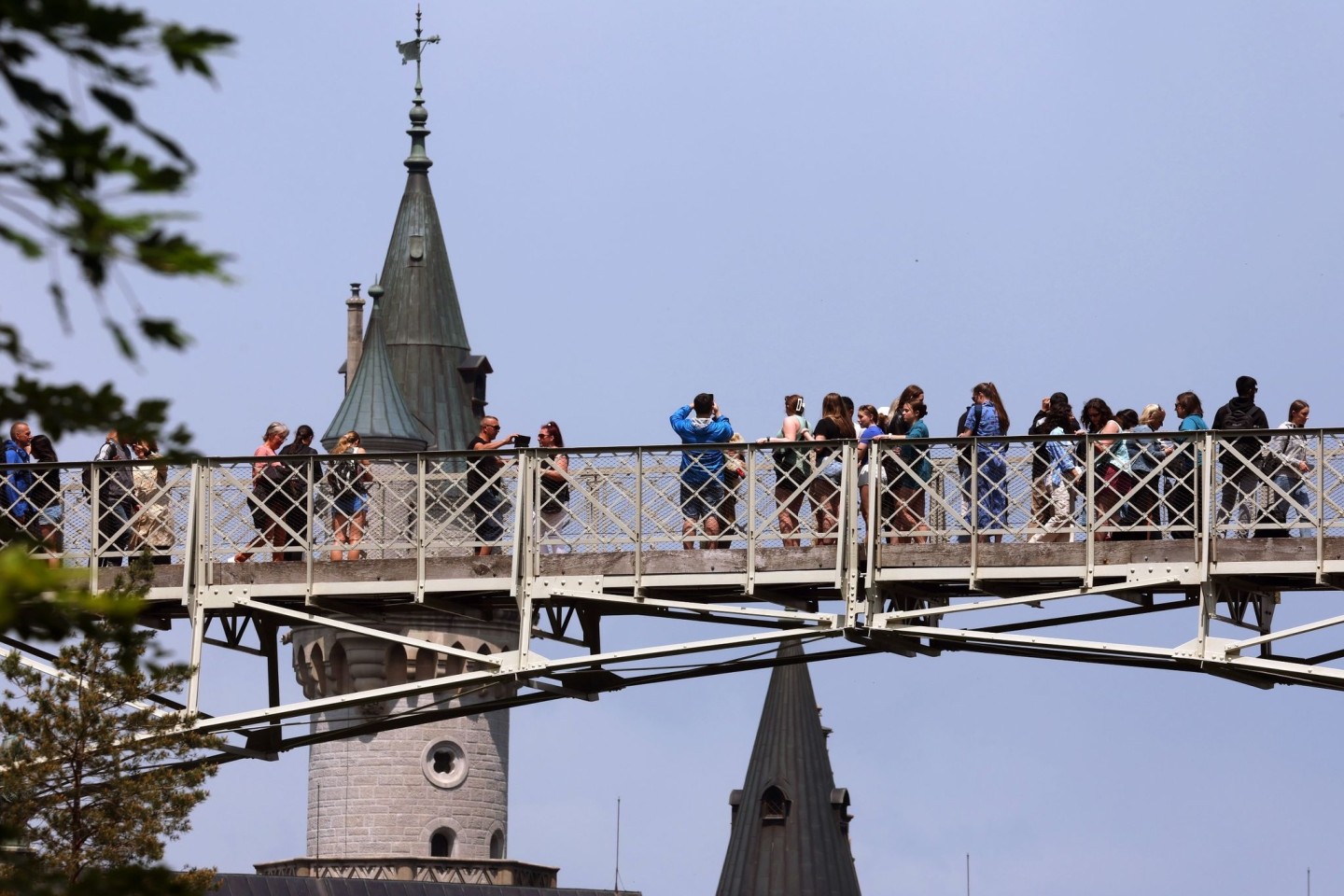 Touristen stehen auf der Marienbrücke vor dem Schloss Neuschwanstein.